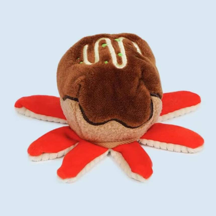 Plush toy shaped like a crab on a light blue background