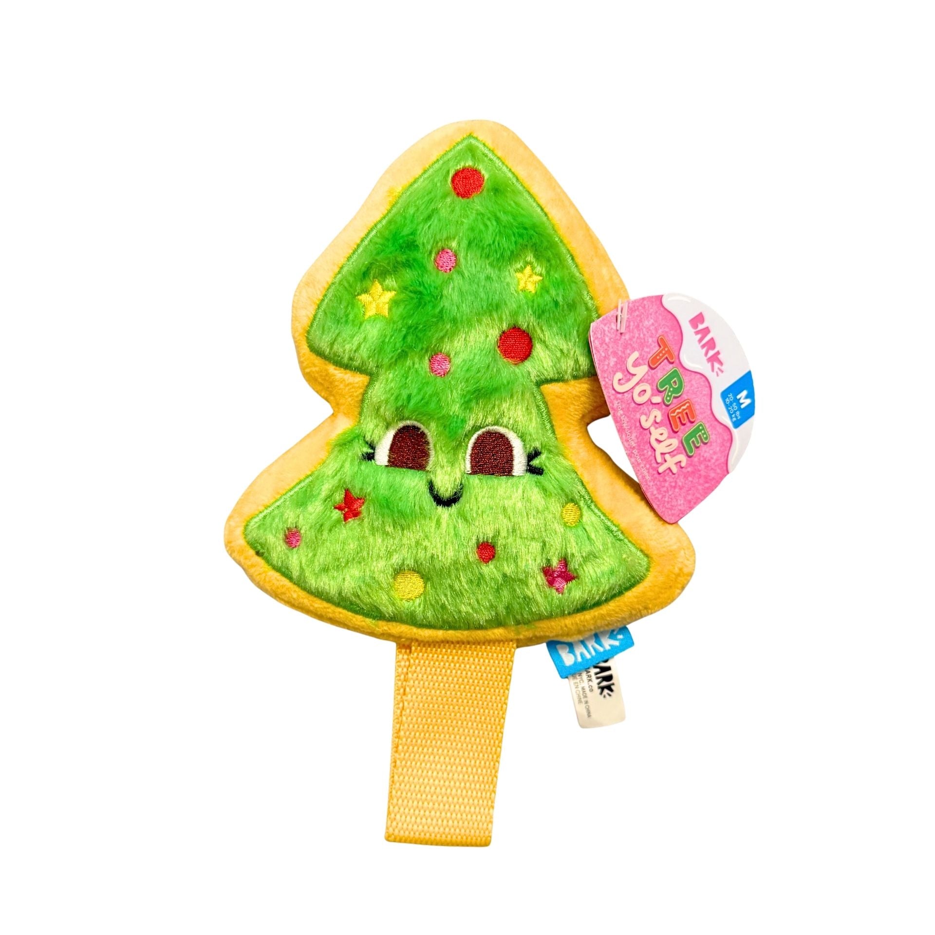 Plush toy shaped like a Christmas tree with a tag on a white background