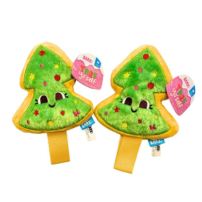 Two green tree-shaped plush toys with yellow bases on a white background