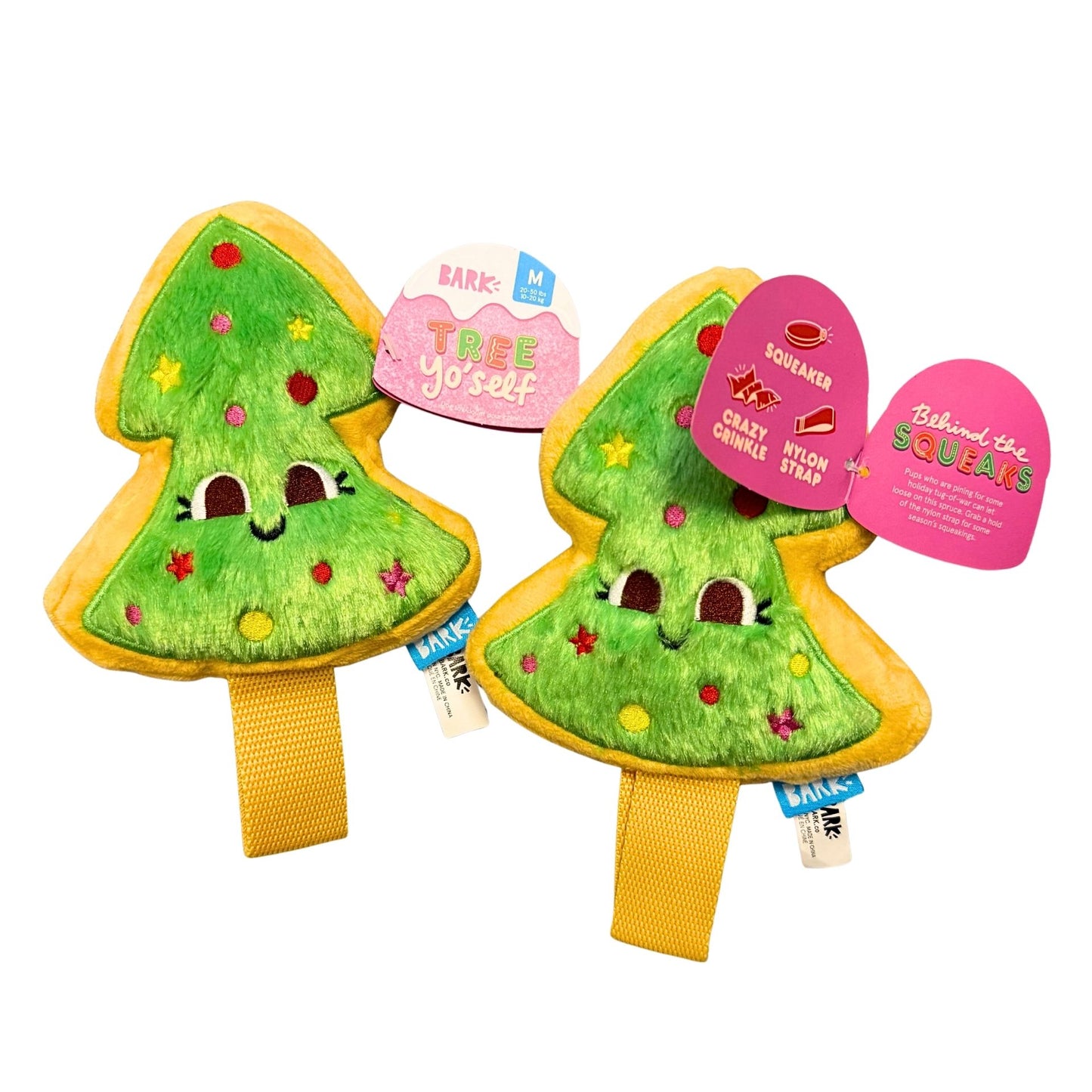 Two green tree-shaped plush toys with yellow bases on a white background